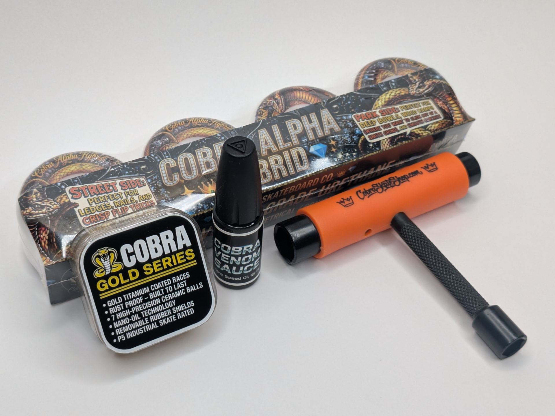 Complete Cobra Loud Pack kit with Alpha Hybrid wheels, Gold Series bearings, Venom Sauce nano-oil, and free skate tool